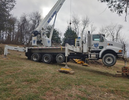 crane moves heavy equipment
